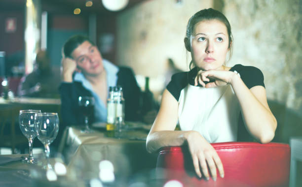 istock woman sitting apart in restaurant with drunk man 918488884