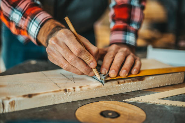 istock Carpenter Measuring a Wooden Plank 918492116