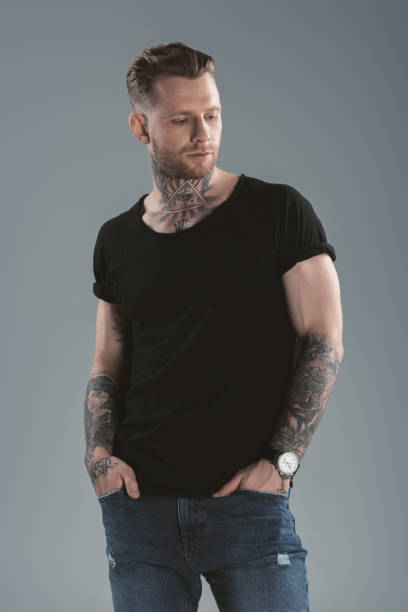 istock handsome tattooed man posing in casual clothes, isolated on grey 918494374