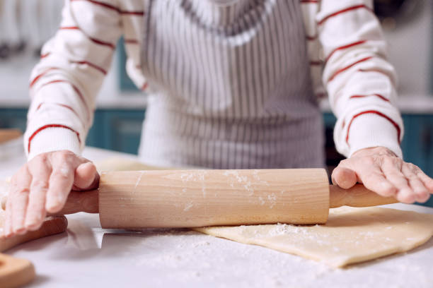 istock Close up of female rolling out dough 918494624