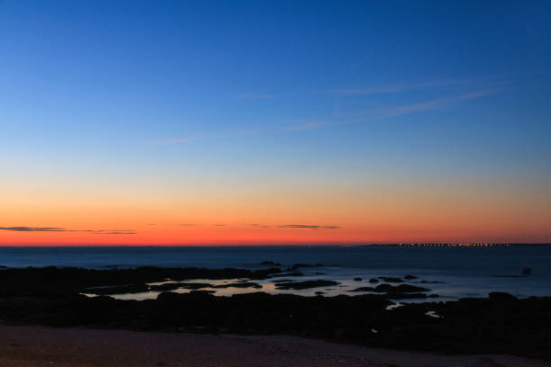 Beautiful landscape view of the vibrant sunset sky at the beach of the Loire-Atlantique in France on a sunny summer day in July