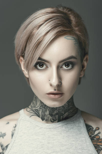istock young attractive tattooed girl, isolated on grey 918497536