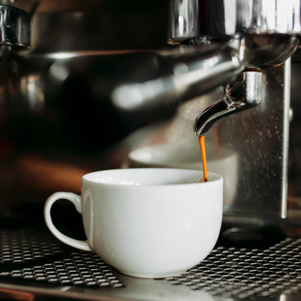 istock Prepare making hot coffee espresso in white glass cup at coffee machine 918497734