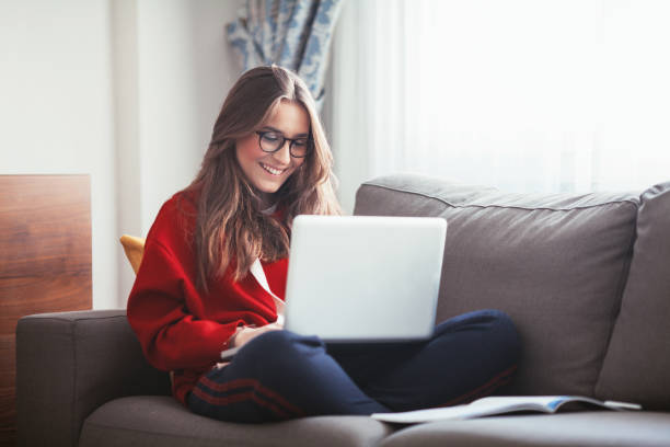 Woman studying on sofa Woman studying on sofa homework stock pictures, royalty-free photos & images