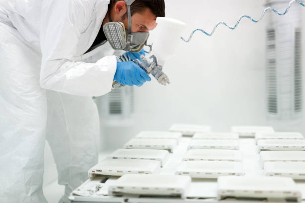istock Painter using airbrush to paint wearing protective clothing 918501592