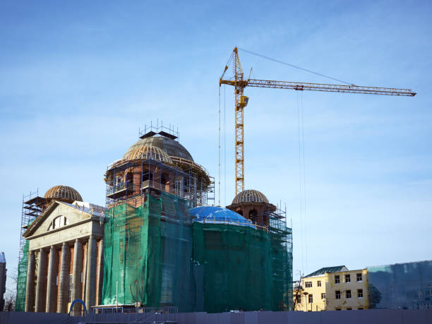 istock View construction new church building, crane, scaffold, sky background 918508958