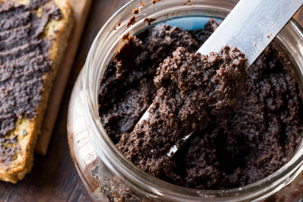 istock Black Olive Tapenade with Knife in Jar 918509282