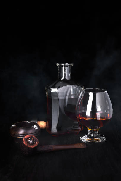 istock Glass of whiskey with smoking cigar. 918509754