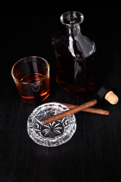 istock Glass of whiskey with smoking cigar. 918509786
