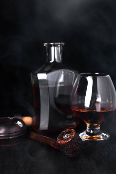 istock Glass of whiskey with smoking cigar. 918509804