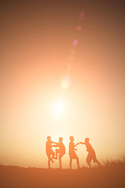 istock Children playing on summer sunset happy time 918511962
