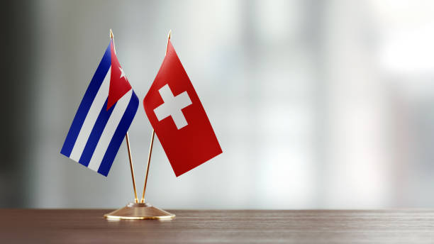 istock Cuban And Swiss Flag Pair On A Desk Over Defocused Background 918512340