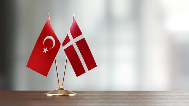 istock Turkish And Danish Flag Pair On A Desk Over Defocused Background 918512546