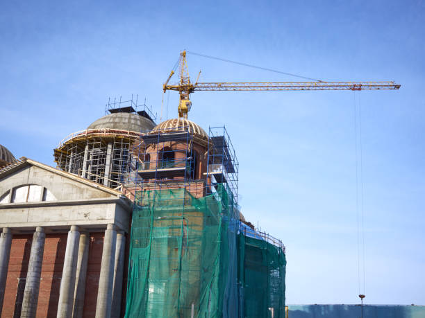 istock View construction new church building, crane, scaffold, sky background 918513136