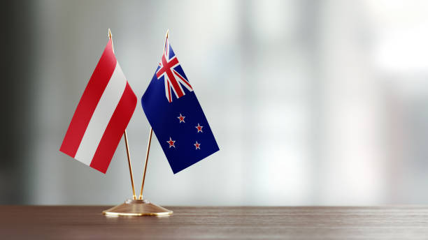 istock New Zealand And Austrian Flag Pair On A Desk Over Defocused Background 918515568