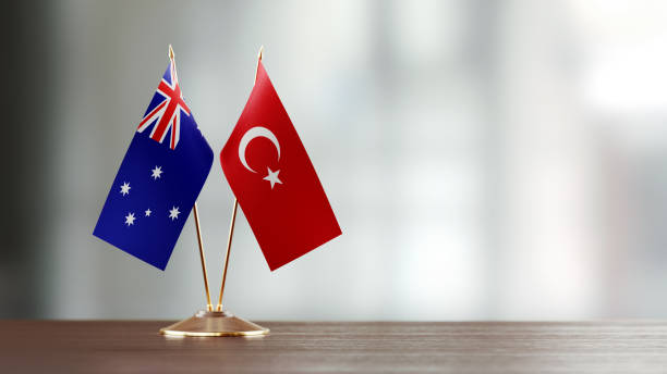 istock Australian And Turkish Flag Pair On A Desk Over Defocused Background 918516268