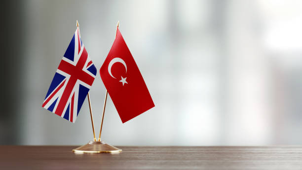 istock British And Turkish Flag Pair On A Desk Over Defocused Background 918516874