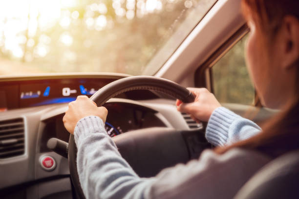 istock Woman driving car at sunny. 918517768