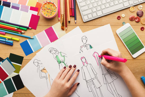istock Top view on woman designer drawing clothes sketches 918521774