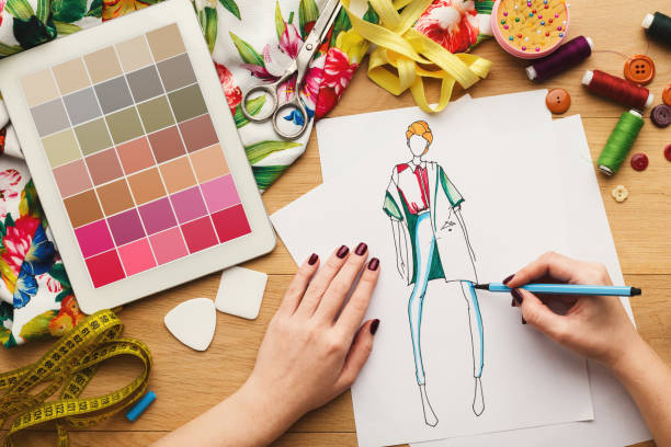 istock Top view on woman designer drawing clothes sketches 918521988