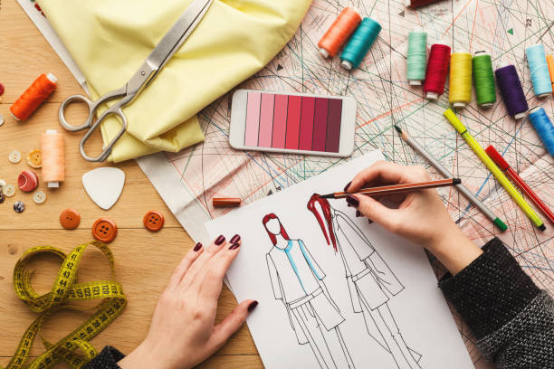 istock Top view on woman designer drawing clothes sketches 918522326