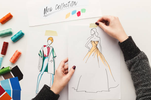 istock Top view on woman designer drawing clothes sketches 918522372