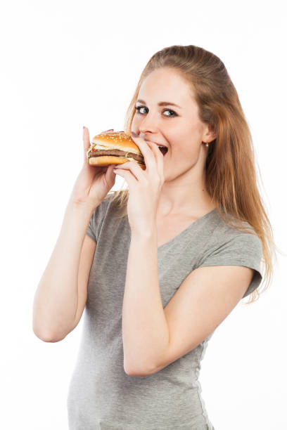 istock Cute girl eating a hamburger 918525648