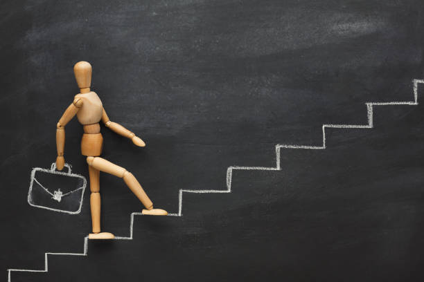 istock Wooden figure on drawn steps 918526248