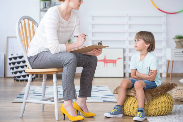 istock Boy listening to child therapist 918527034