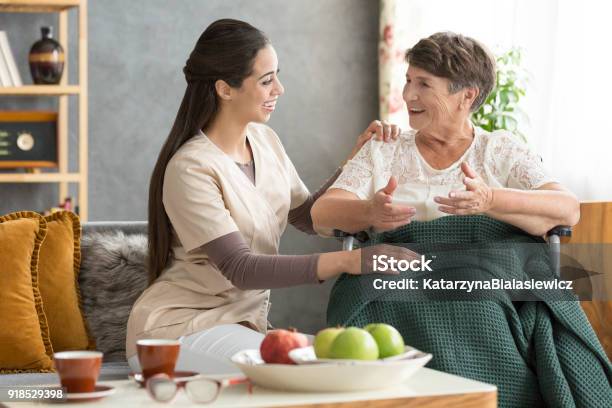 Happy Senior Woman And Caregiver Stock Photo - Download Image Now - Hospice, Home Caregiver, Senior Adult