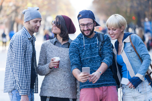 istock Young people walking on street and taking selfie 918529524