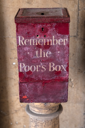 A Remember the Poors Box located at St. Bartholomews Hospital in London, UK.  Before the National Health Service, the sick were dependent on charity and public-giving was encouraged.