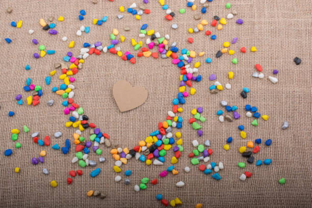 istock Paper heart in another heart form shaped by pebbles 918530886