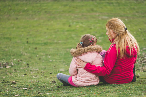 istock Mother and daughter talking in the park 918537066