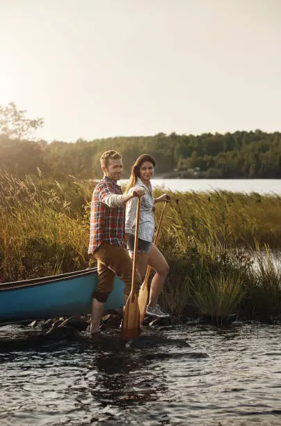 Portrait of a young couple going for a canoe ride on the lake
