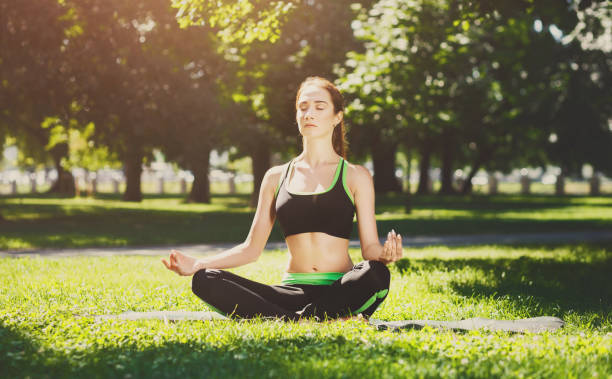istock Young woman outdoors, relax meditation pose 918538336