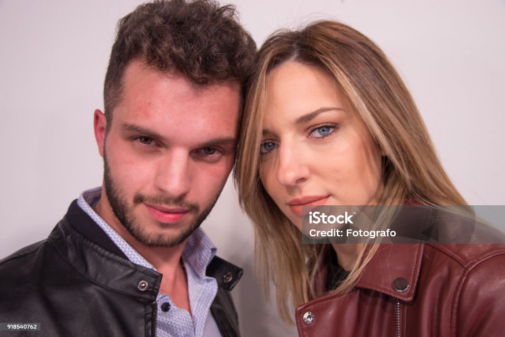 Portrait of a mid adult man and a young woman smiling portrait of beautiful young couple smiling, on white background Adult Stock Photo