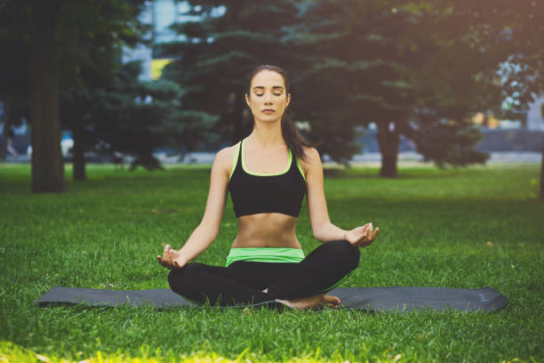 istock Young woman outdoors, relax meditation pose 918541164