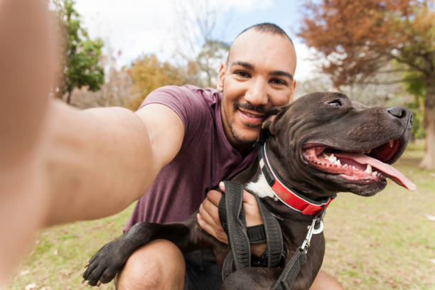 istock Young man hanging out with his dog taking selfies. 918544802