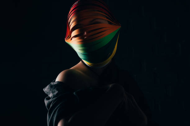 istock woman with colored quilling paper on head isolated on black 918545824