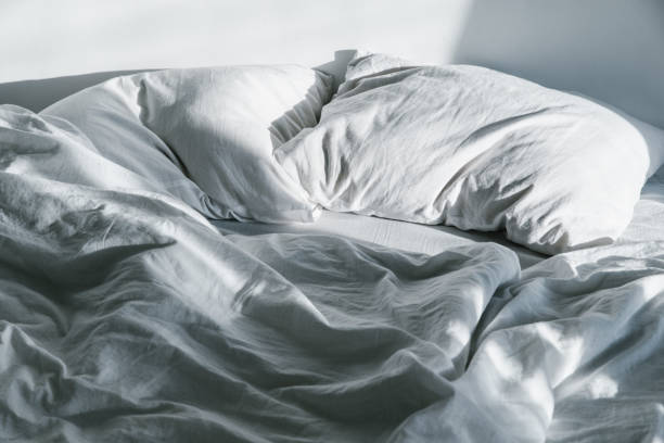 istock crumpled bed on sunrise sun lights 918545944