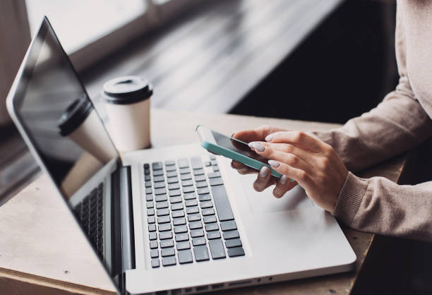 istock Businesswoman using smart phone and laptop 918548364