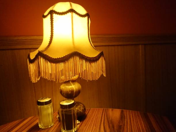 istock Retro styled lamp on wooden table 918548564