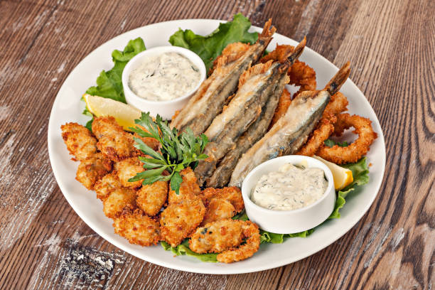 istock Plate with fish snack with white sauce and greens. 918552206