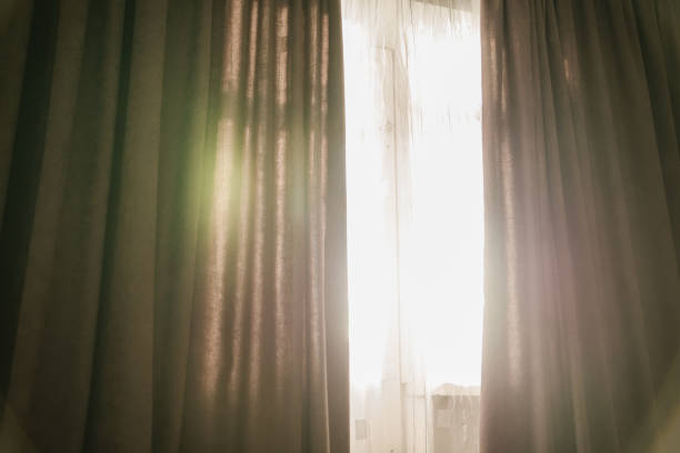 istock sunshine trough window with curtains 918555626