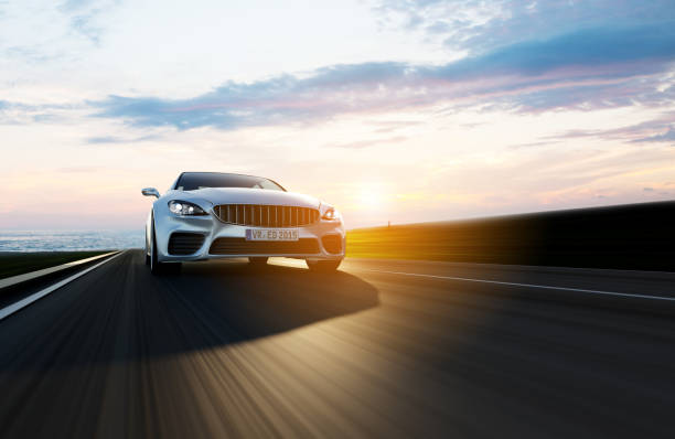 istock car driving on a road by sea 918555756