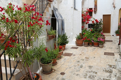 Grottaglie, Italy - street view with flower pots in Apulia region.