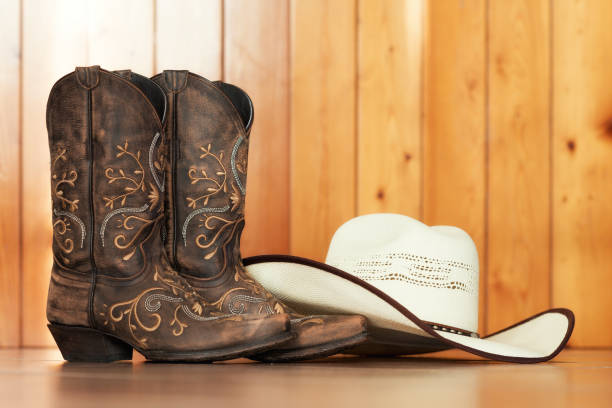 line dance boots and hat cowgirl embroidered boots and white hat on wooden background - text space cowgirl stock pictures, royalty-free photos & images