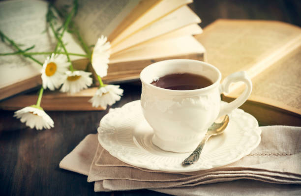 istock Cup of tea with a books and chamomiles 918557410