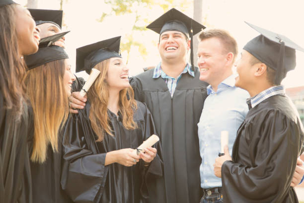 istock College students and friends after graduation ceremony. 918562242